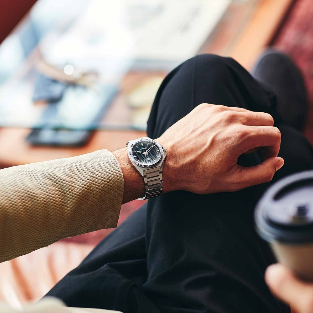 Mies Citizen-kellolla, istuu kahvin kanssa, lähikuva. Tyylikäs ja moderni.